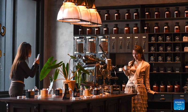 People take photos at a coffee shop at a commercial complex in Guiyang, southwest China's Guizhou Province, Jan. 8, 2026. The city of Guiyang has been committed to the update and renovation of old commercial blocks, streets and factory areas. The renewed streets, such as Taiping, Minsheng, and Qingyun Roads have become vibrant spaces for relaxation and spending, driving urban consumption vitality and enhancing the city's youthful appeal. Photo: Xinhua