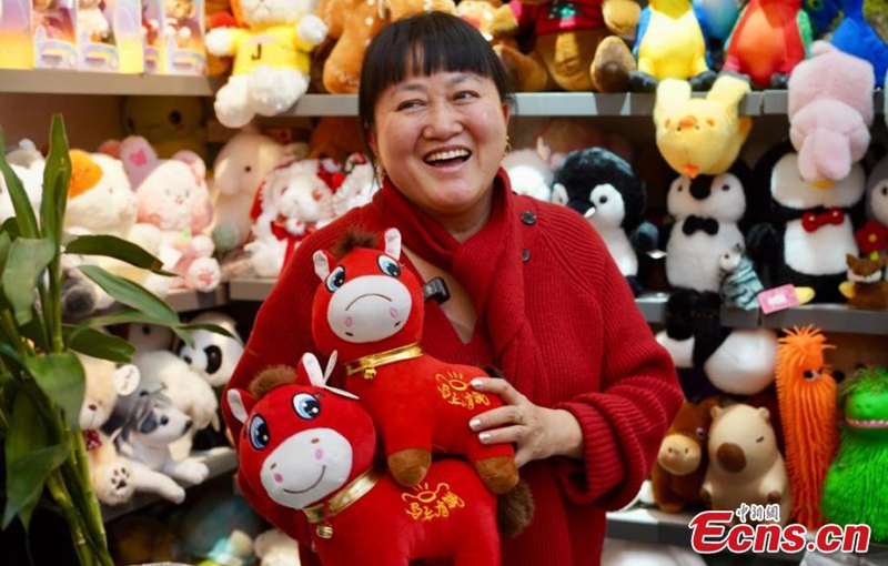Zhang Huoqing, a merchant in Yiwu, Zhejiang Province, smiles as she displays the 