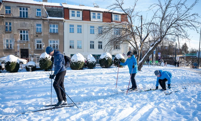 People play on a snow-covered field in Prague, the Czech Republic, Jan. 11, 2026. (Photo by Dana Kesnerova/Xinhua)