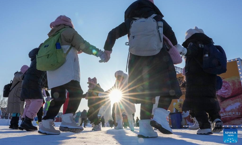 Tourists dance on the frozen surface of the Songhua River in Harbin, northeast China's Heilongjiang Province, Jan. 10, 2026. The surface of the Harbin section of Songhua River, now solidly frozen, serves as a fun field, where locals and tourists alike enjoy themselves with ice-and-snow-themed amusements. (Xinhua/Wang Jianwei)