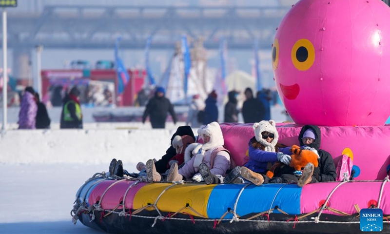 Tourists play on the frozen surface of the Songhua River in Harbin, northeast China's Heilongjiang Province, Jan. 11, 2026. The surface of the Harbin section of Songhua River, now solidly frozen, serves as a fun field, where locals and tourists alike enjoy themselves with ice-and-snow-themed amusements. (Xinhua/Wang Jianwei)
