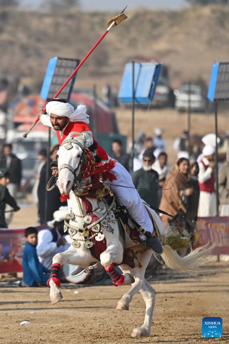A rider competes during a tent pegging competition in Islamabad, Pakistan, Jan. 11, 2026. In tent pegging, a horseman gallops and uses a sword or a lance to pierce, pick up and carry away a wooden peg. Photo: Xinhua