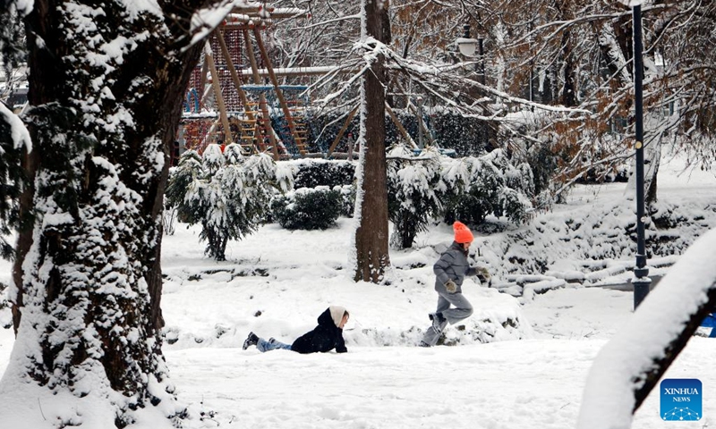 Children run amid snowfall at a park in Bucharest, Romania, on Jan. 11, 2026. Romania is facing a severe winter episode, with snowfall, blizzards, persistent frost and extremely low temperatures in large parts of the country. Photo: Xinhua