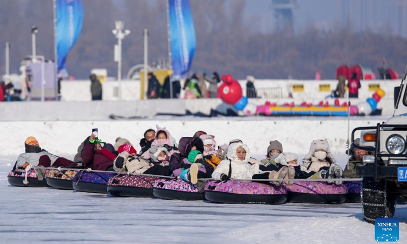 Tourists play on the frozen surface of the Songhua River in Harbin, northeast China's Heilongjiang Province, Jan. 11, 2026. The surface of the Harbin section of Songhua River, now solidly frozen, serves as a fun field, where locals and tourists alike enjoy themselves with ice-and-snow-themed amusements. (Xinhua/Wang Jianwei)