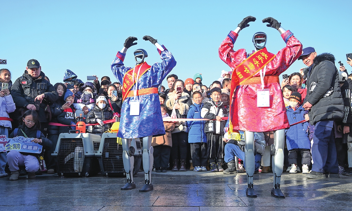 Robots perform a dance routine in a public square in Hohhot, North China's Inner Mongolia Autonomous Region, on January 13, 2026. On the same day, a robot 