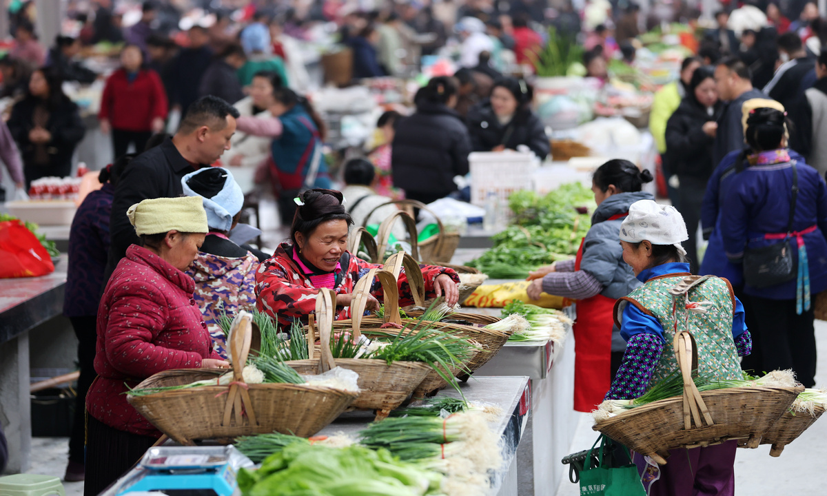 Vendors sell fresh vegetables at a farmer's market in Rongjiang, Qiandongnan Miao and Dong Autonomous Prefecture in Southwest China's Guizhou Province, on January 18, 2026. The upgraded market, offering 302 stalls across six themed zones, helps boost the livelihoods of local farmers. Photo: VCG