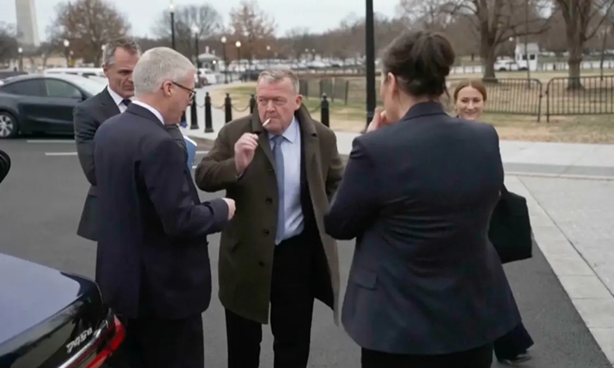 Foreign Ministers Lars Rasmussen of Denmark (center) and Vivian Motzfeldt of Greenland (right with back to the camera) light up cigarettes outside the White House after a meeting with US Vice President JD Vance and Secretary of State Marco Rubio on January 14, 2026. Photo: screenshot of video circulating on X