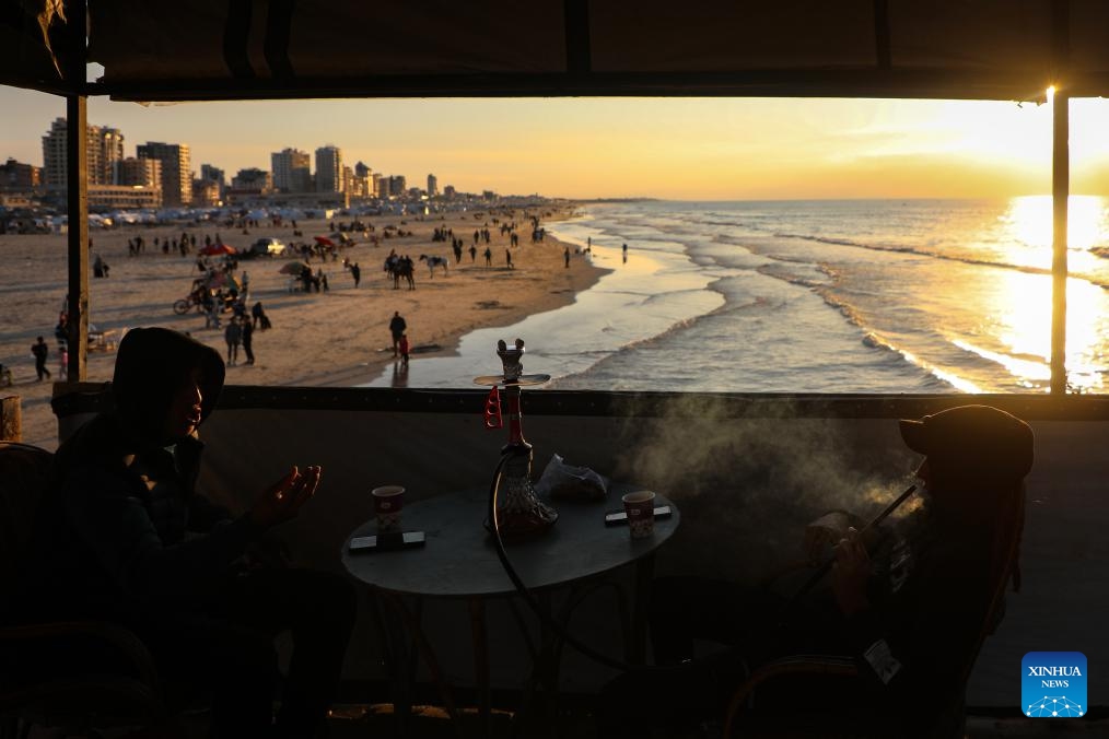 Palestinians spend time on a beach in Gaza City at sunset, Jan. 16, 2026. (Photo: Xinhua)