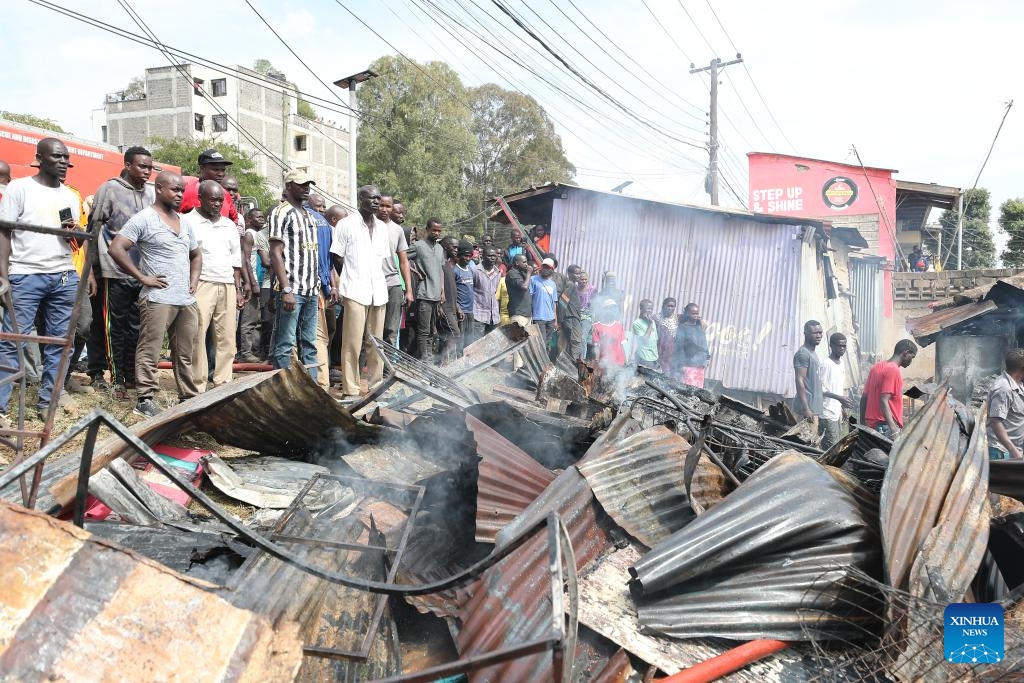 People gather around the debris of houses burned down during a fire at Kibera slum in Nairobi, Kenya, on Jan. 17, 2026. A fire broke out here on Saturday, causing dozens of houses burned down. No casualties have been reported yet. (Photo: Xinhua)