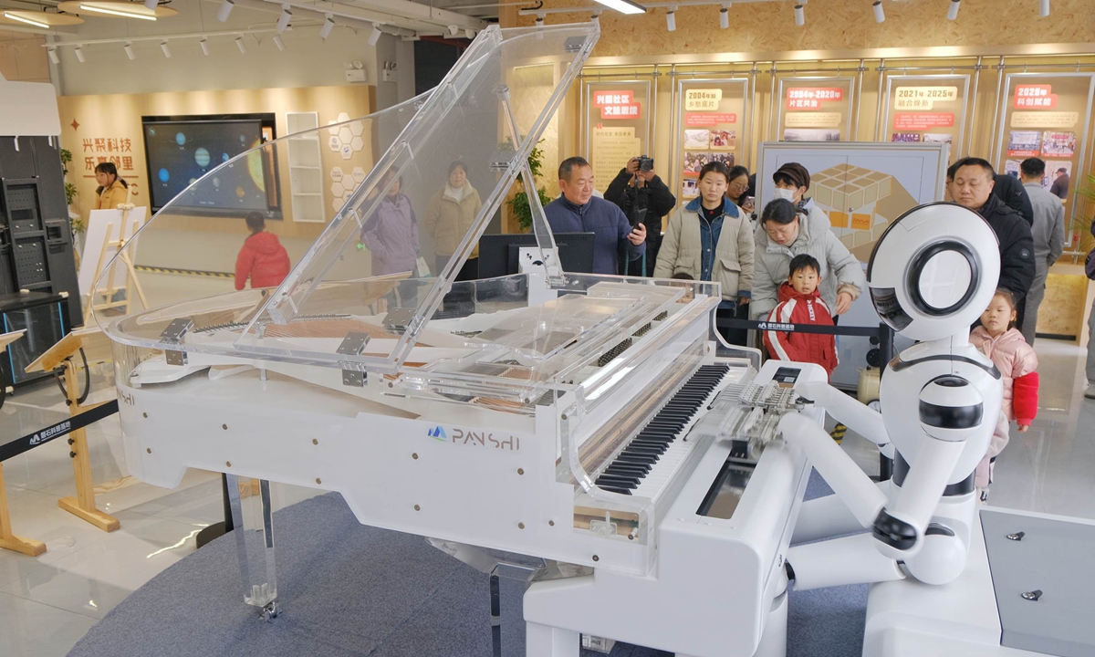 Visitors watch a robot play the piano at a technology museum opening to the public for the first time in Hefei, East China's Anhui Province, on January 18, 2026. Designed with multifunctional spaces, the museum aims to create a 