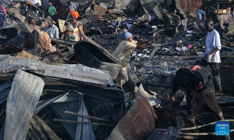 People clean the debris of houses burned down during a fire at Kibera slum in Nairobi, Kenya, on Jan. 17, 2026. A fire broke out here on Saturday, causing dozens of houses burned down. No casualties have been reported yet. (Photo: Xinhua)
