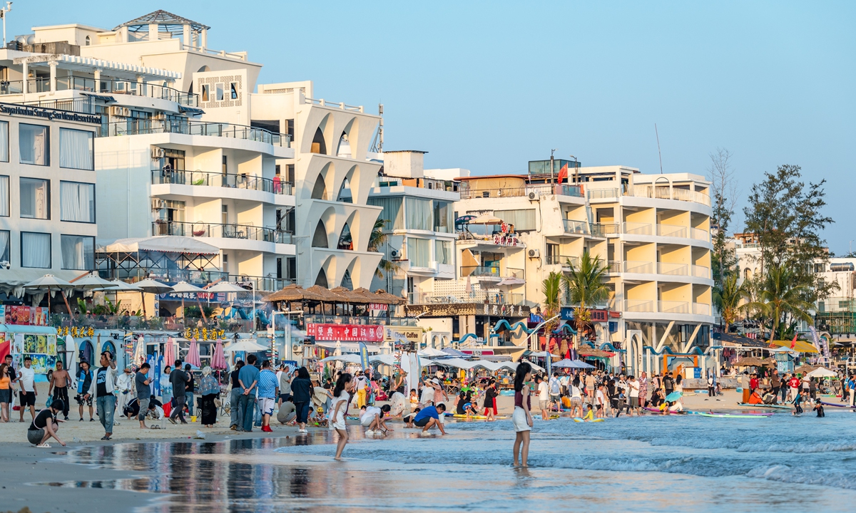 Tourists experience surfing in the waters of Houhai Village, in Sanya, South China's Hainan Province on January 17, 2026. Photo: VCG