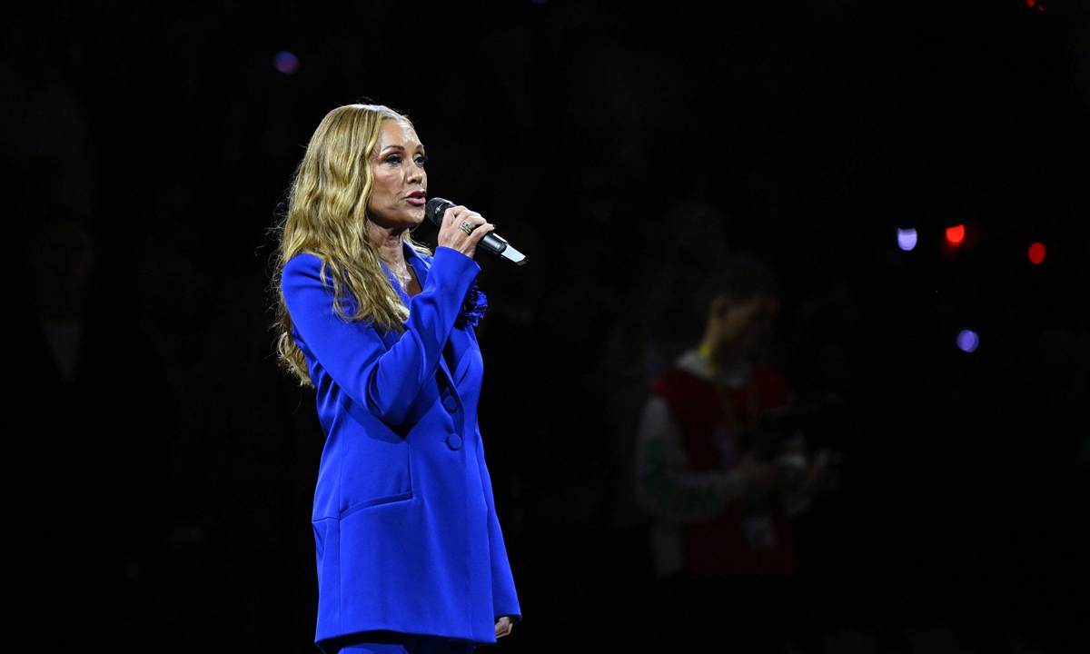 American singer Vanessa Williams performs the US national anthem as an audience member shouts 