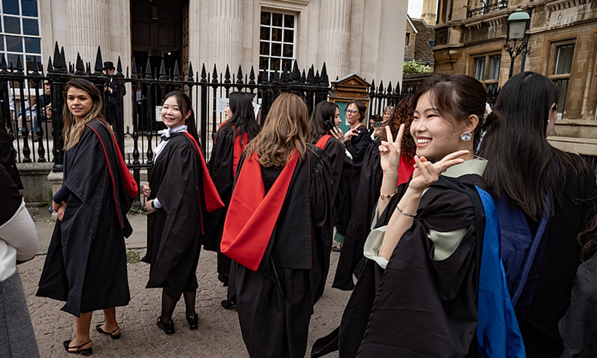 Cambridge University Graduation Day on 3 May 2025. Students queue along King's Parade waiting to enter the Senate House to receive their degrees on May Day Weekend. Seen Here: Students from the all female Murray Edwards College. Photo: VCG