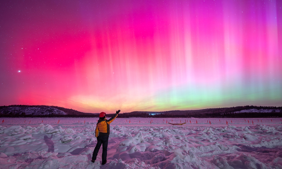 Triggered by a geomagnetic storm, a rare and spectacular aurora borealis lights up the sky over the Heilongjiang River in Luoguhe Village, known as the 