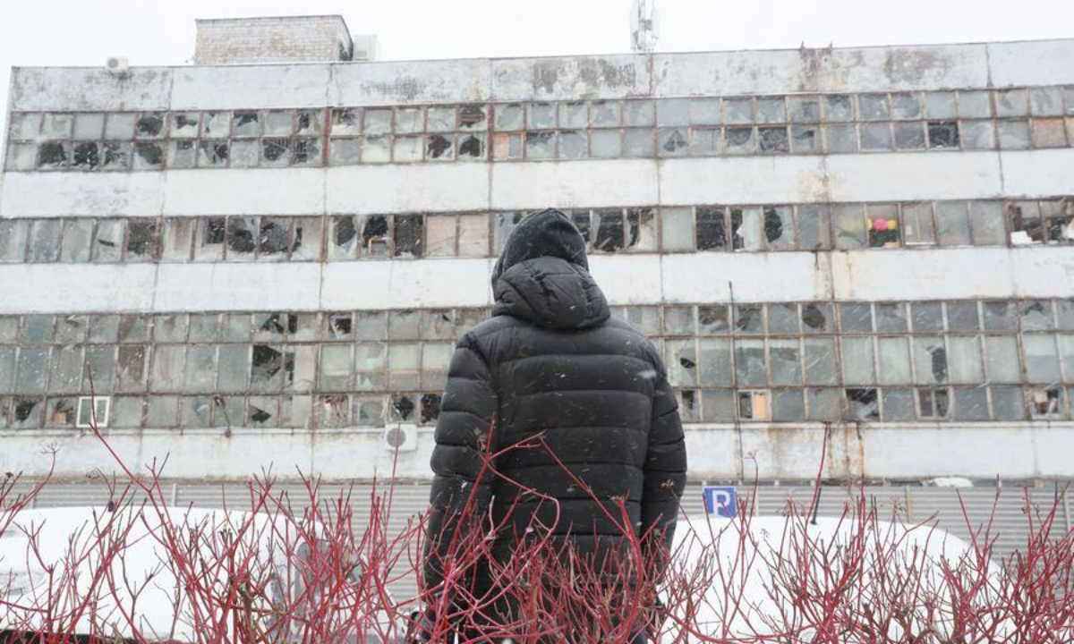 A man looks at a damaged residential building after a massive drone and missile attack by Russia, in Kiev, Ukraine, Jan. 9, 2026. (Xinhua/Li Dongxu)