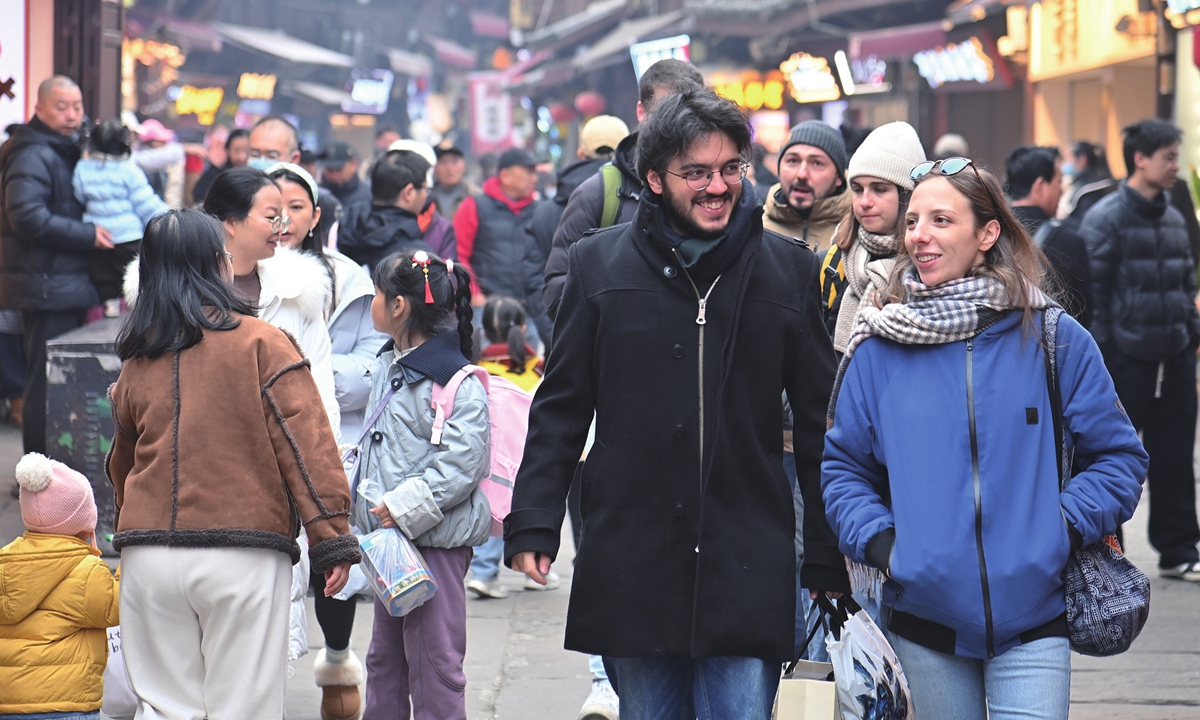 A photo shows an ancient town in Chongqing on January 11, 2026, where Chinese and foreign tourists stream through the streets in an endless flow. Photo: VCG