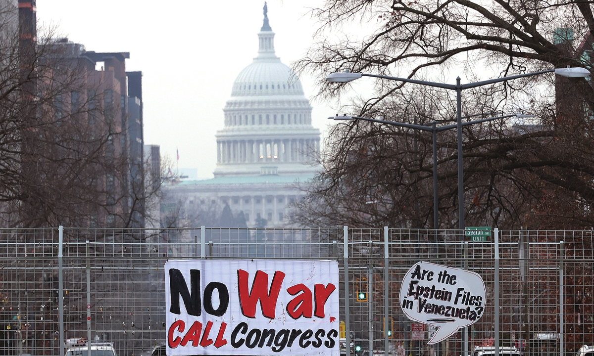 A sign opposing US military intervention in Venezuela hangs on an overpass near the US Capitol in Washington, DC on January 6, 2026. Photo: VCG