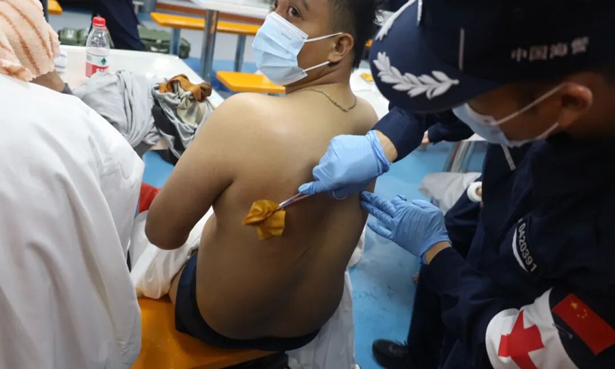 CCG medical personnel helping a rescued Philippine crew member Photo: CCG’s official WeChat account.