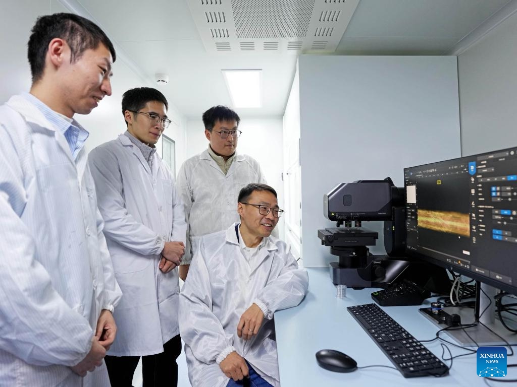 Researchers look at an enlarged image of a fiber chip on a computer screen at Fudan University in east China's Shanghai, Jan. 19, 2026. (Xinhua/Liu Ying)

