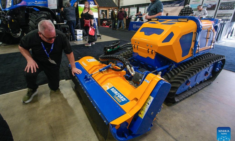 A man looks at a remote-controlled mower at the 2026 Pacific Agriculture Show in Abbotsford, British Columbia, Canada, Jan. 22, 2026. The event kicked off here on Thursday and runs until Jan. 24. (Photo by Liang Sen/Xinhua)
