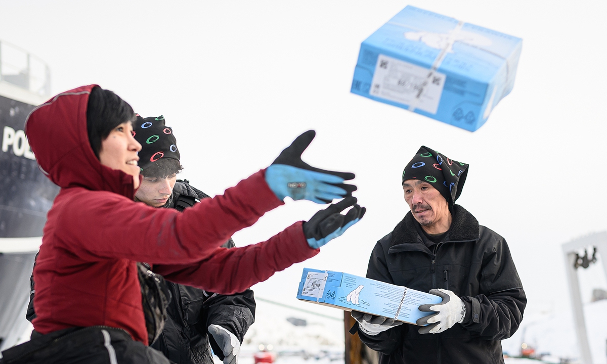 Members of a packing crew stack boxes of freshly-caught prawns after they are unloaded from the <em>Polar Nataarnaq</em> stern trawler, on March 27, 2025 in Nuuk, Greenland. Photo: VCG