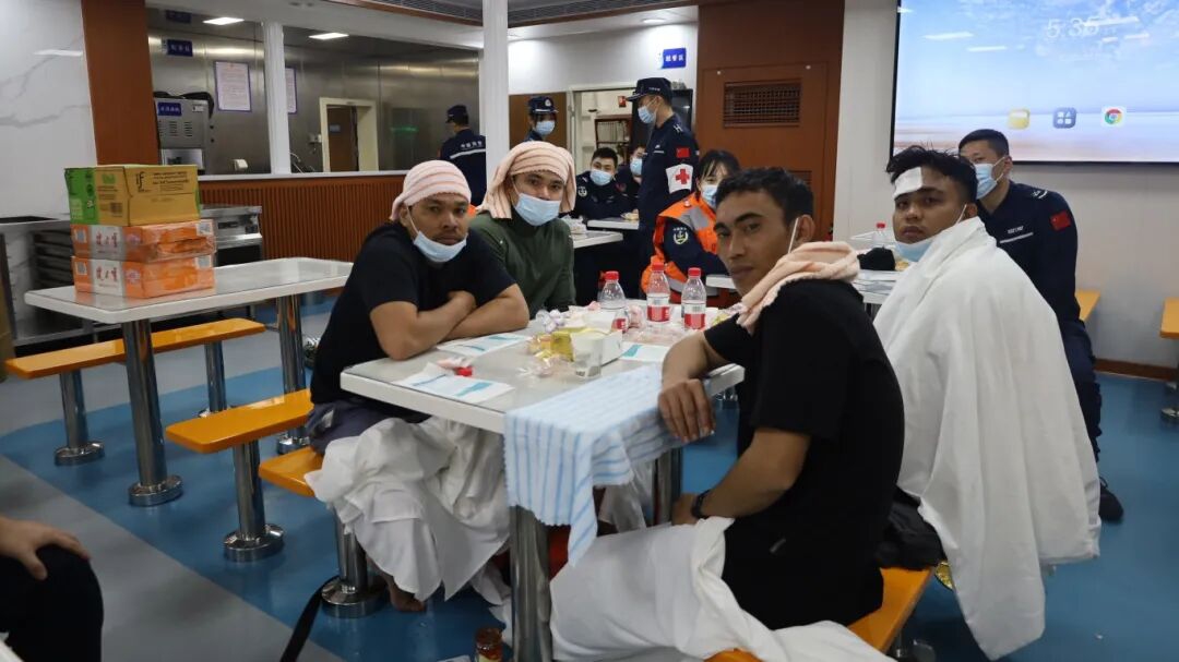 Philippine crew members sit in a cafeteria onboard a CCG's vessel Photo: CCG’s official WeChat account.