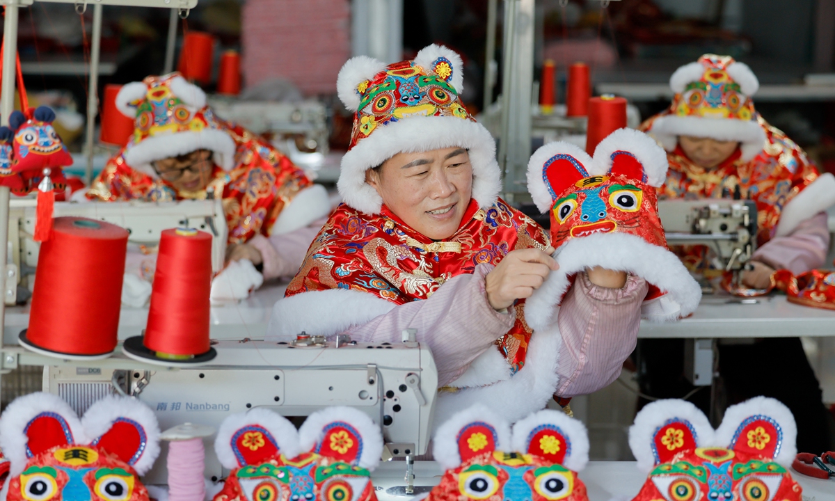 Employees at a handmade products enterprise process various types of distinctive folk craft products in Yuncheng City, North China's Shanxi Province on January 26, 2026. With the Spring Festival approaching, local workers are producing characteristic folk items such as tiger-head hats, shawls, and sachets to meet the demand as it is a peak sales season for folk products. Photo: VCG