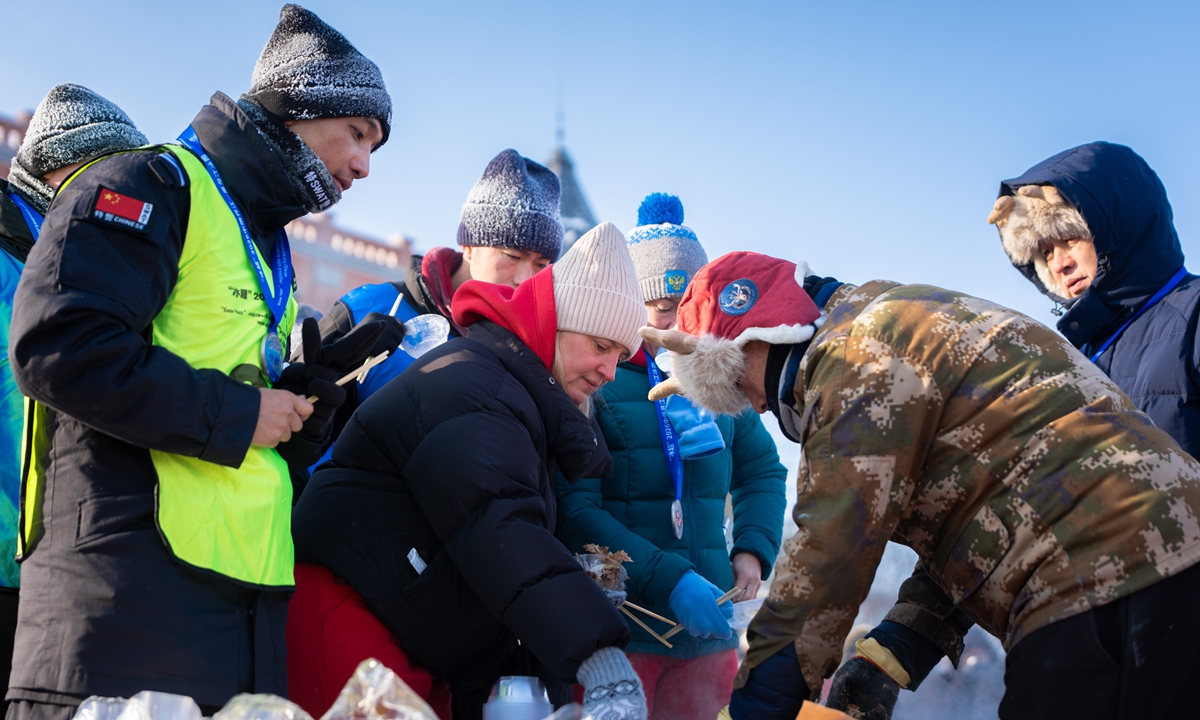 Chinese and Russian runners, spectators enjoy local Chinese cuisines after an ice running event held on January 18, 2026 on the frozen Heilongjiang River. Photo: Courtesy of organizers