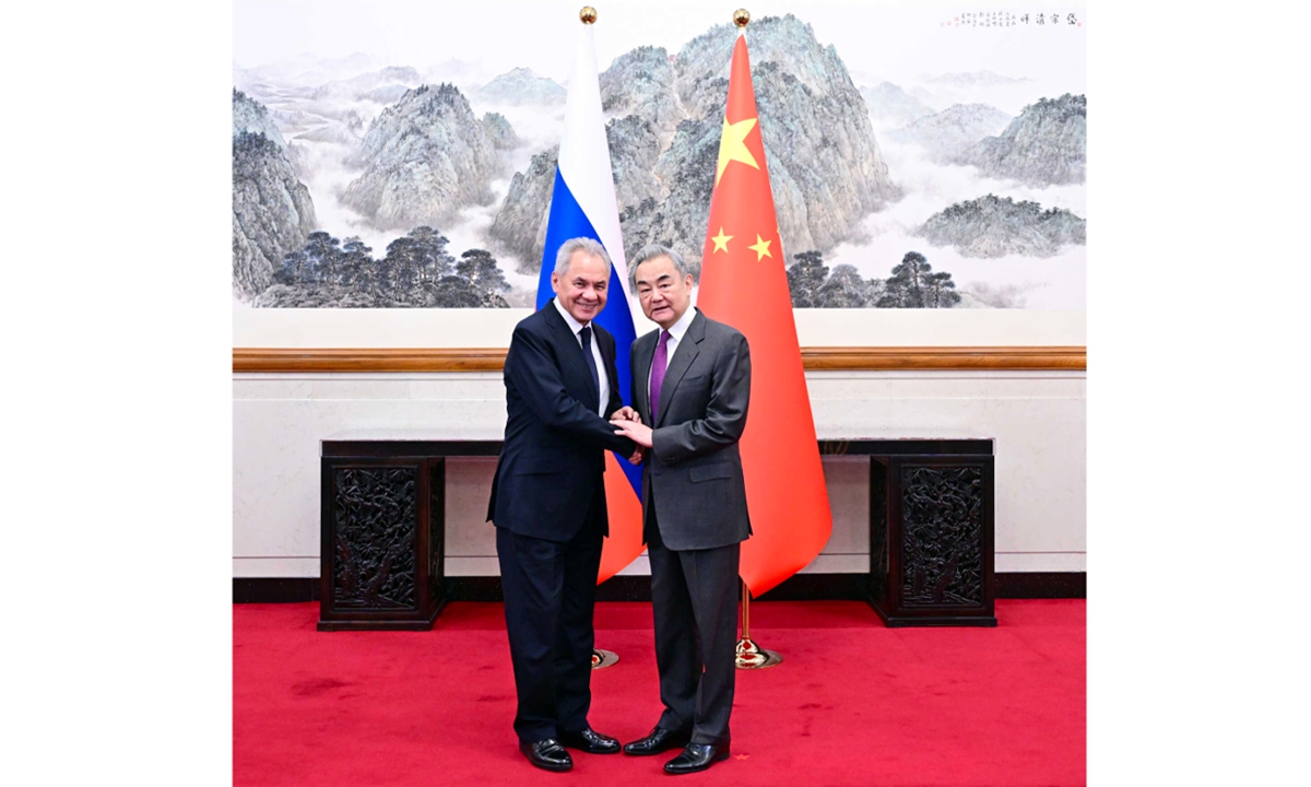 Chinese FM holds strategic dialogue with Russia's Shoigu; Wang warns the world 'faces risk of regressing to law of jungle'