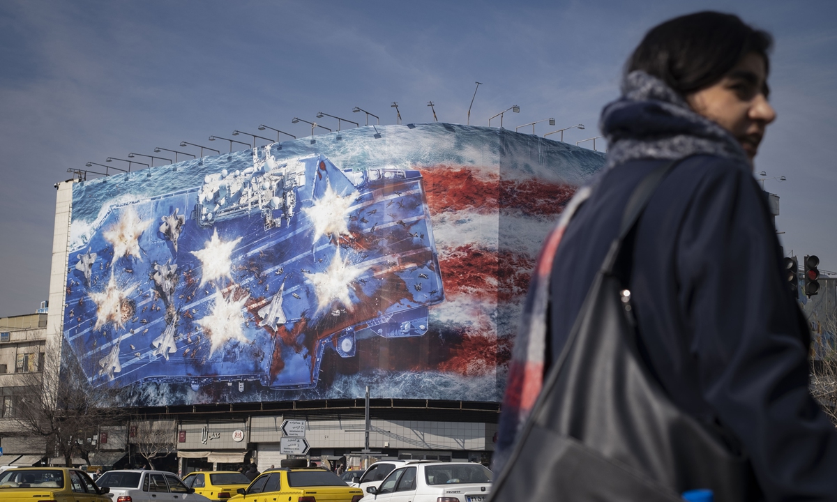 A mural warns the US against attempting a military strike on Iran at Enghelab Square in Tehran, Iran.