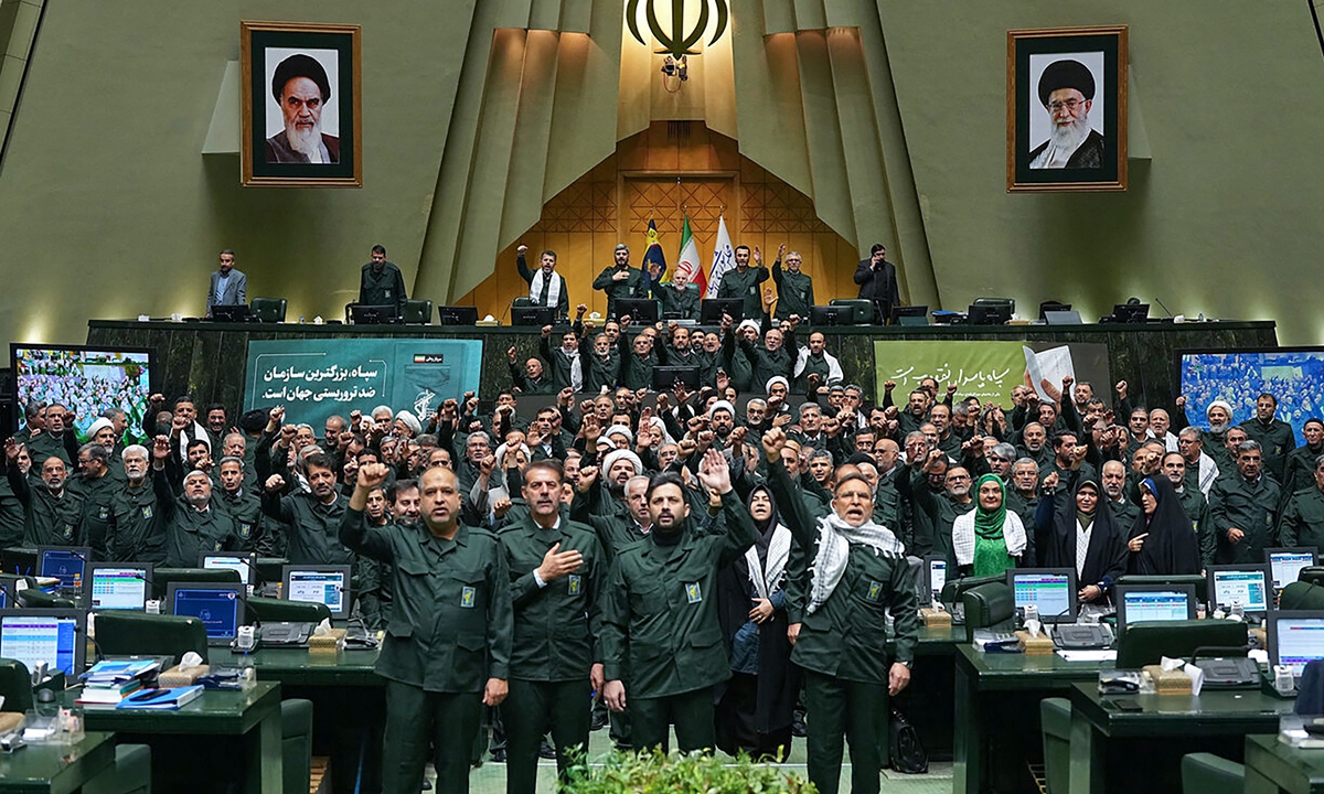 Members of Iran's parliament dressed in Islamic Revolutionary Guard Corps (IRGC) uniforms chant Death to America during a session in Tehran on February 1, 2026, as Iran designated the armies of European countries as 