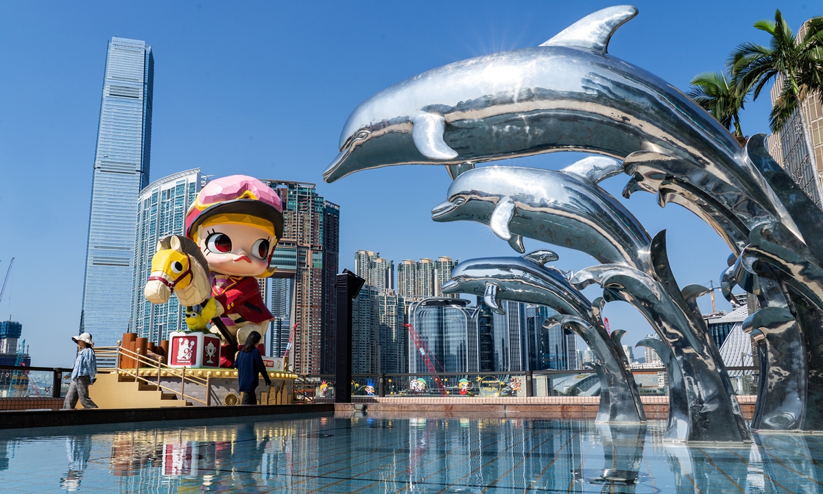 People walk past a 7-meter-tall jockey statue of Pop Mart's MOLLY that incorporates elements of the Year of the Horse at the terrace garden of China Hong Kong City in Tsim Sha Tsui, the Hong Kong Special Administrative Region, on February 2, 2026. Photo: VCG