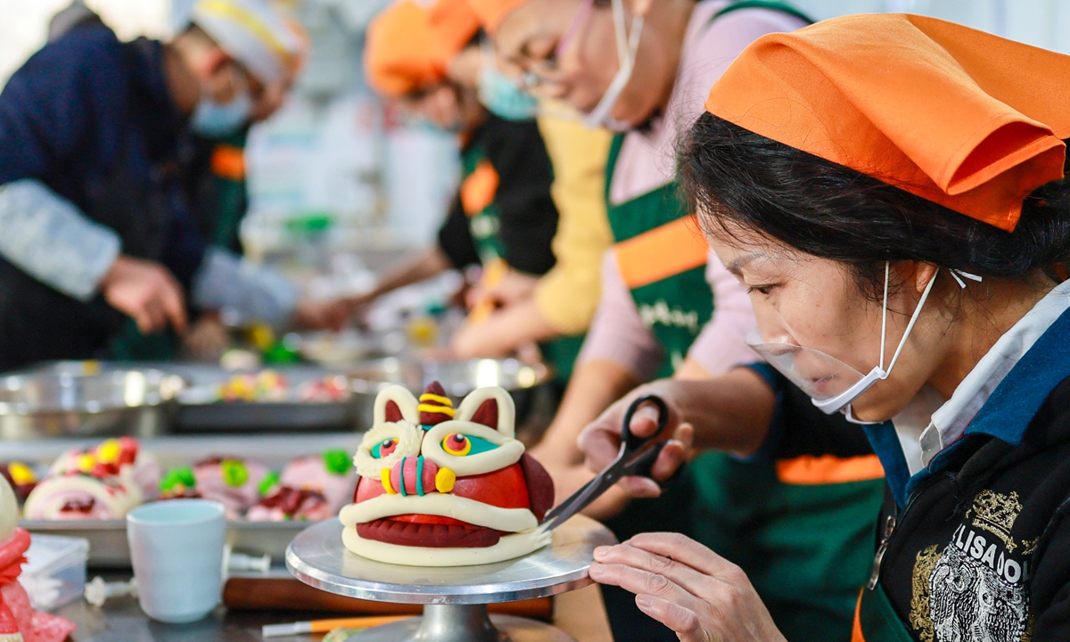 Participants make huamo (flower-shaped steamed buns) at an intangible cultural heritage handicraft activity held in a vocational training school in Hohhot, North China's Inner Mongolia Autonomous Region on February 2, 2026. Under the guidance of pastry instructors, trainees who participated in the free workshop shaped and decorated the dough, using this traditional craft to convey good wishes for the Chinese Lunar New Year. Photo: VCG