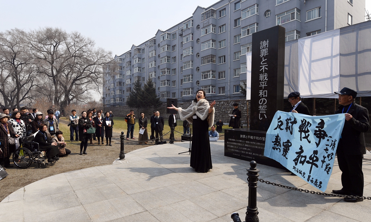 A woman sings in front of an apology and anti-war monument at the former site of Unit 731 in Harbin, Northeast China's Heilongjiang Province, on April 4, 2017. She is a member of a delegation of Japanese war orphans and friendly Japanese people who were visiting China. Photo: VCG