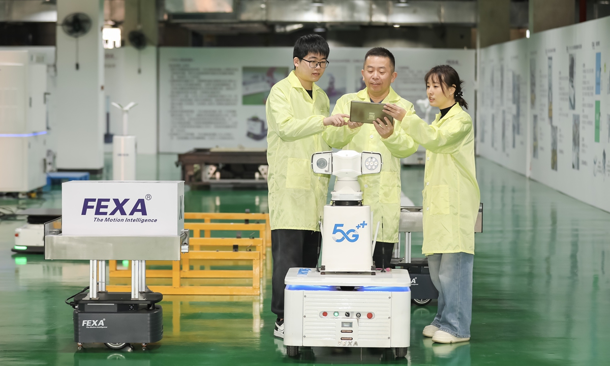 Engineers at a technology company debug a 5G intelligent inspection robot at an information technology application innovation industrial park in Fuzhou, East China's Fujian Province, on February 4, 2026. Companies in the park are operating at full capacity to fill overseas orders, aiming for a strong start to the first quarter. Photo: VCG