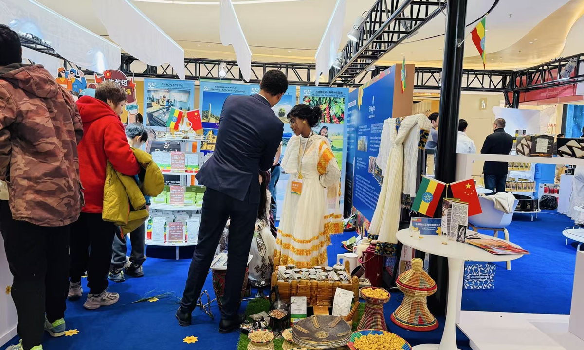 Customers browse and inquire about coffee products at a booth hosted by the Ethiopian Embassy during the first 2026 