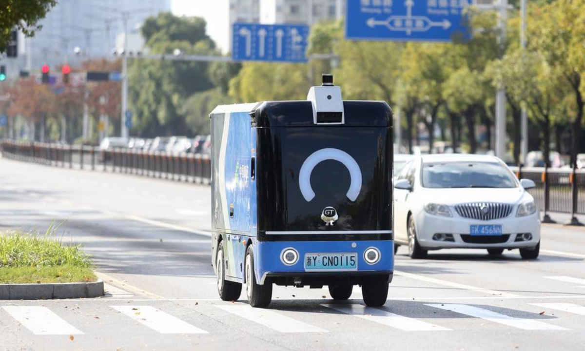 A self-driving delivery vehicle transports packages in Yangzhou City, east China's Jiangsu Province, Nov. 11, 2025. (Photo by Meng Delong/Xinhua)
