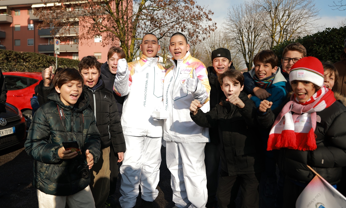 Torchbearers Arthur Li and Carter Li, 14-year-old twin brothers from Shenzhen, South China's Guangdong Province, participate in the Olympic torch relay in Milan, Italy on February 5, 2026. Photo: Courtesy of SZMS Nanshan Innovation School