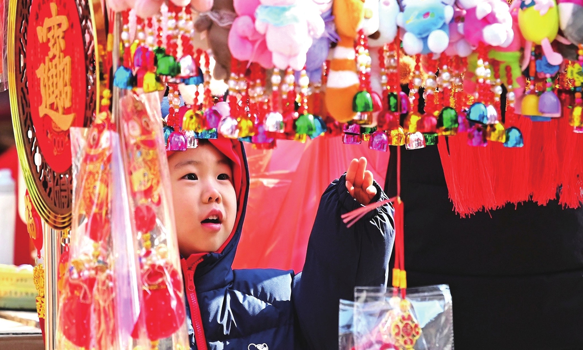 A boy selects his favorite Spring Festival decorations and ornaments at a market in Tengzhou, East China's Shandong Province, on February 7, 2026. Photo: VCG