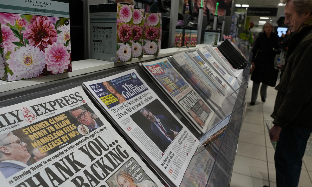 A man looks at newspapers on sale showing headlines relating to the Epstein files in London on February 5, 2026. Photo: VCG