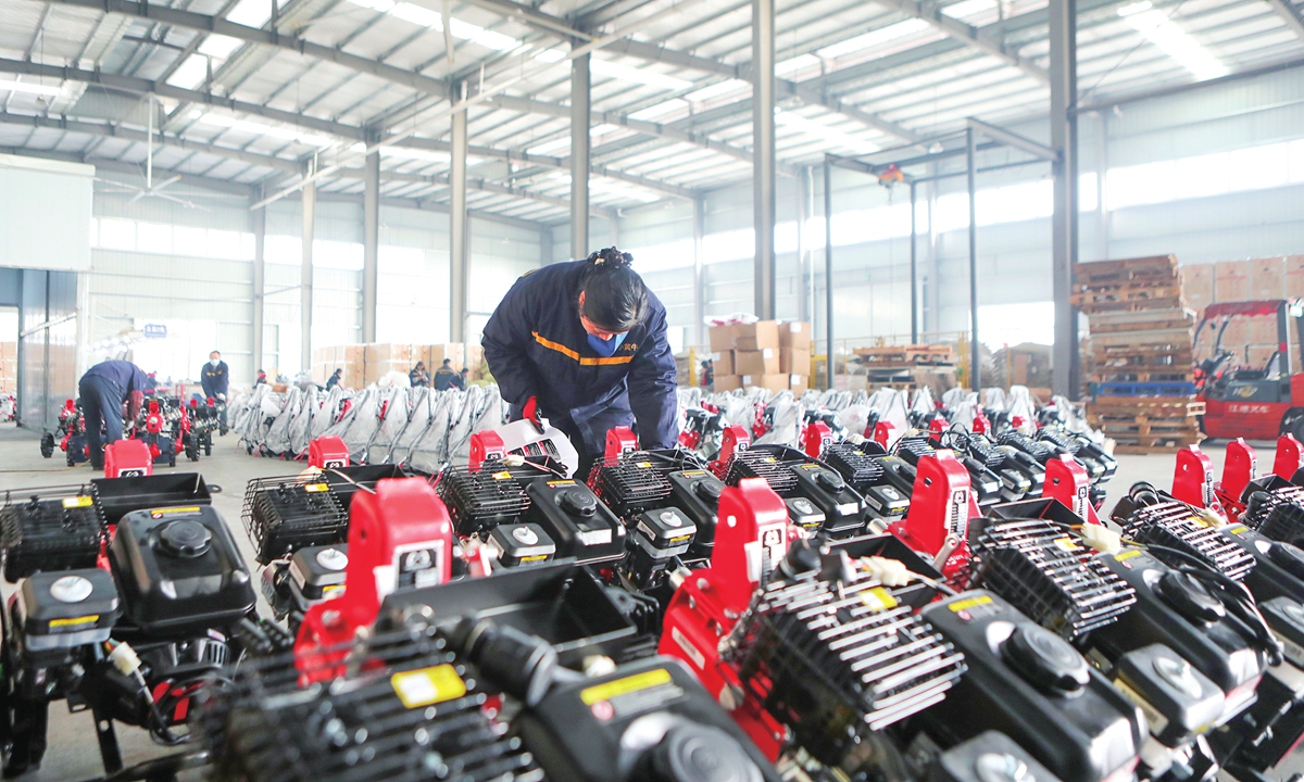 Workers inspect mini tillers bound for India at an agricultural machinery company in Yongchuan, Southwest China's Chongqing, on February 11, 2026. The workshop director said the order - totaling 8,000 units - marked the company's 