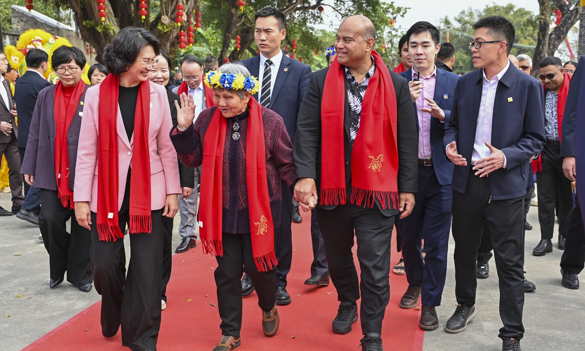 President of Nauru David Adeang (second from right, front row) strolls with his great-grandaunt Tan Huixia in Zhonggu village, located in Jiangmen, South China's Guangdong Province on February 11, 2026. The Nauru President has led a delegation to his ancestral hometown to celebrate the
