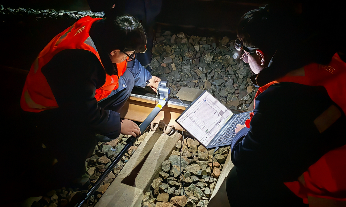 Members of the grinding team use a rail profile inspection analyzer along with related computer software to precisely measure rail wear patterns at Beijing South Railway Station, on January 30, 2026. Photo: Liang Rui/GT