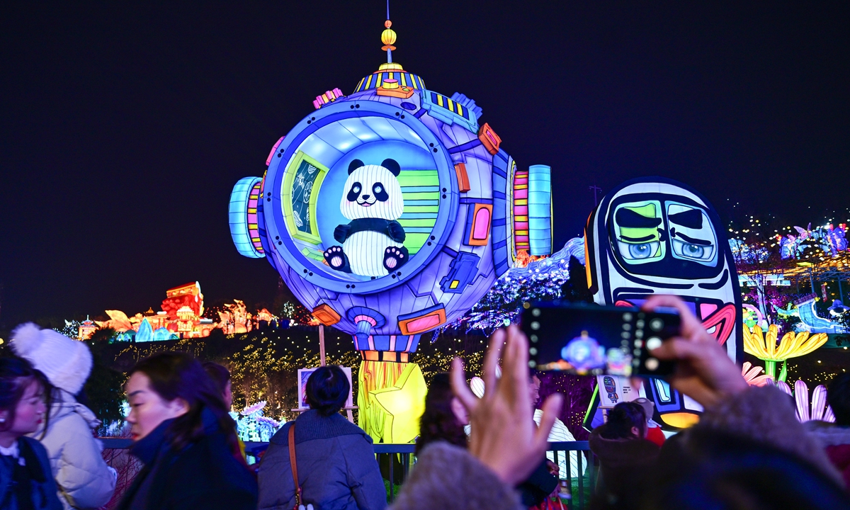 People explore the Zigong International Dinosaur Lantern Festival. Photo: VCG