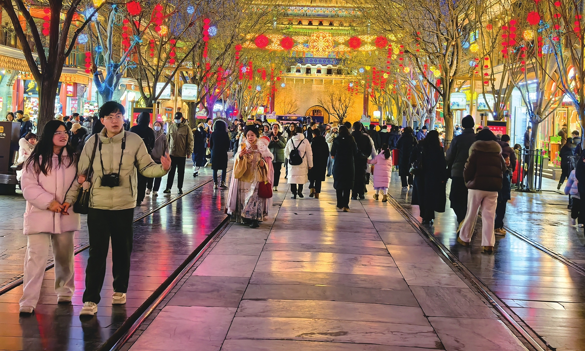 Tourists visit the Qianmen pedestrian street in Beijing on February 1, 2026. Photos on this page: VCG
