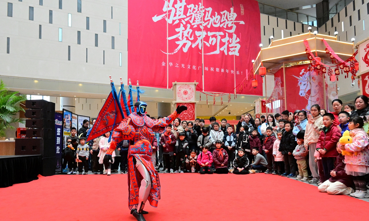A humanoid robot dressed as a performer of Wuju opera interacts with residents and tourists at a local science and technology museum in Jinhua, East China's Zhejiang Province on February 13, 2026. Photo: VCG