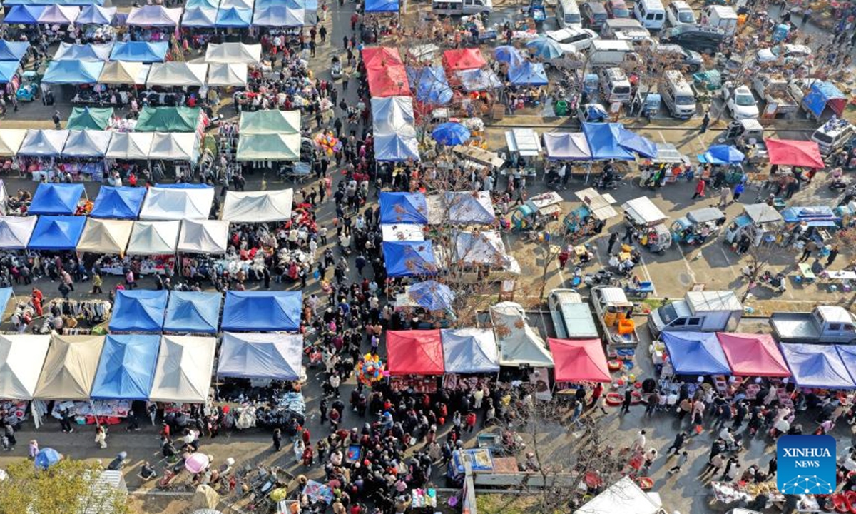 This aerial drone photo shows people purchasing goods needed for the Chinese New Year celebrations at a market in Xianju County of Taizhou City, east China's Zhejiang Province, Feb. 11, 2026. Markets across the country are bustling nowadays as people flock there to stock up on goods in preparation for the upcoming Spring Festival, or the Chinese New Year. (Photo by Wang Huabin/Xinhua)

