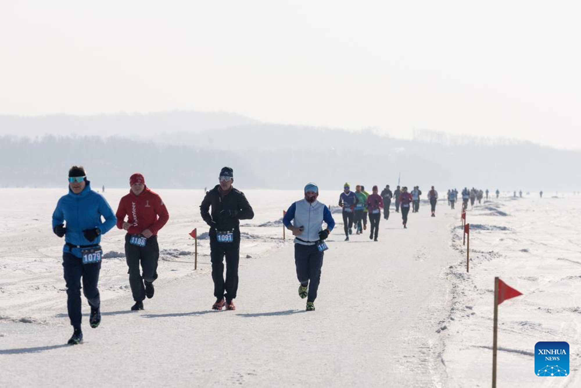 Participants take part in an ice half marathon held on the frozen sea in Vladivostok, Russia, Feb. 14, 2026. (Photo by Andrey Matveenko/Xinhua)

