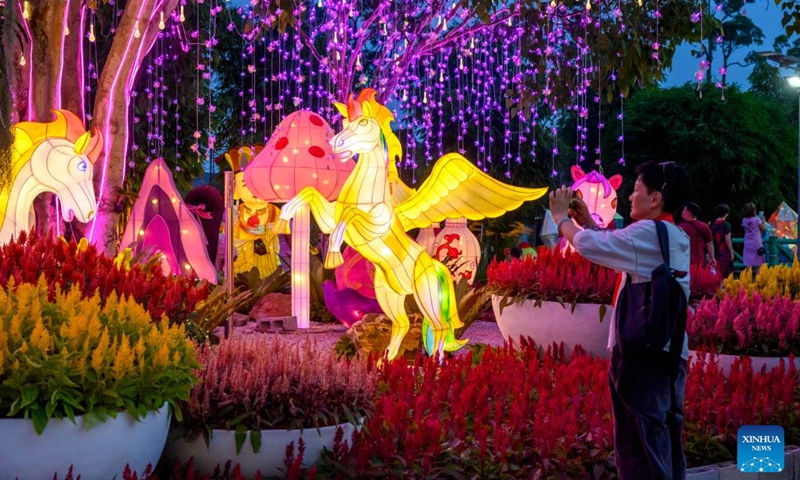 A tourist takes photos at a lantern fair in celebration of the upcoming Year of the Horse in Selangor state, Malaysia, Feb. 14, 2026. (Photo by Chong Voon Chung/Xinhua)